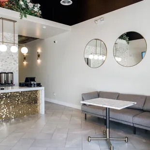 a living room with a couch and a coffee maker