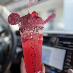 a person holding a cup with a drink in it