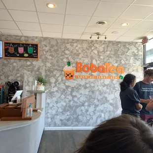 a man and a woman standing in front of a counter