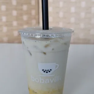 Passion fruit puree with oat milk and added boba