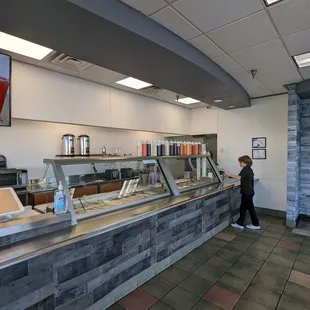 a boy standing in front of a counter