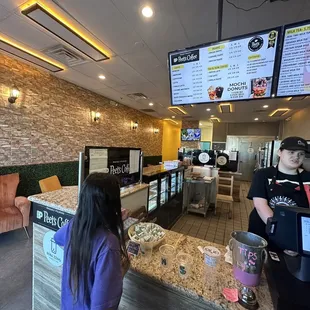 a woman ordering food at the counter