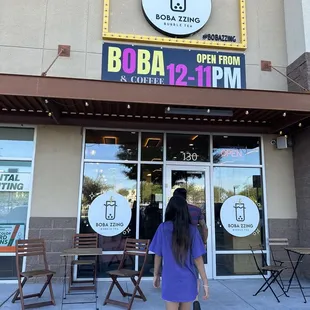 a woman walking in front of a restaurant