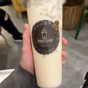 a person holding a cup of boba