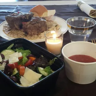 Oxtails &amp; gravy over rice dinner accompanied by salad of bold flavors &amp; raspberry vinaigrette.
