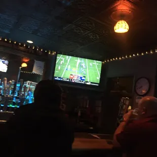 two men sitting at the bar