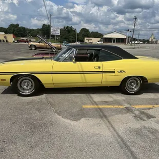 a yellow car parked in a parking lot