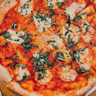 a pizza with cheese and spinach