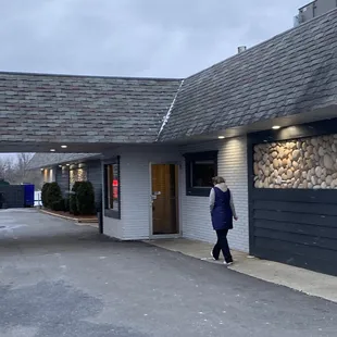 a woman walking out of the door