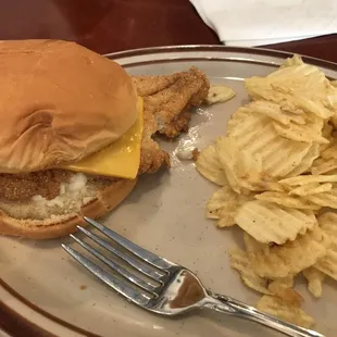 Fried catfish sandwich with chips.