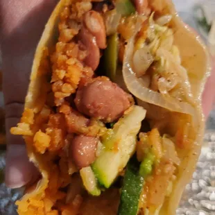 Inside of Monster Burrito with Fajita Veggies, Rice, Boiled Beans, Cabbage, and Guac.