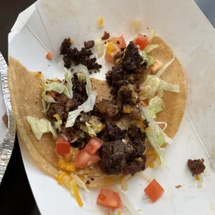 Burnt ground beef in taco.