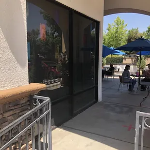 a patio with tables and umbrellas