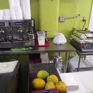 Coffee (café) and pressed sandwich work area. Also present: mangos