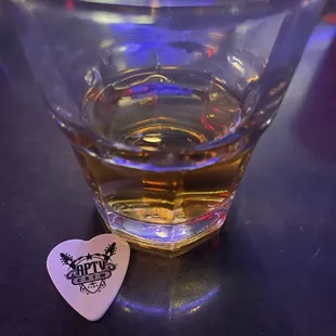 a guitar pick in a glass