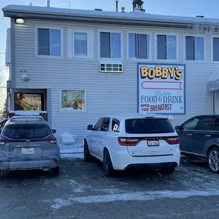 two cars parked in front of a building