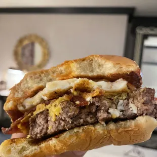 a hand holding a hamburger