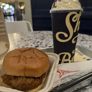 Chicken sandwich and strawberry shake.