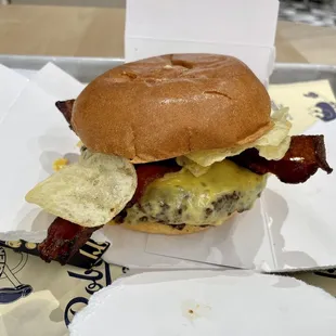 a burger with bacon and cheese