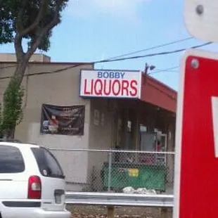 a white car and a red and white sign