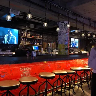 a man standing in front of the bar