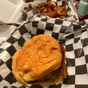 a burger and fries on a checkered table cloth