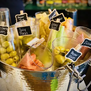 a bucket of pickles and olives