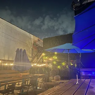 a patio with tables and umbrellas
