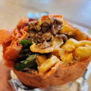 a hand holding a burrito