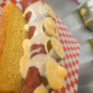 a hot dog covered in cheese and toppings