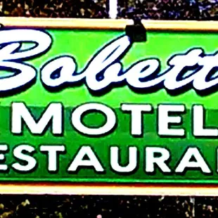 a neon sign for bobette motel restaurant