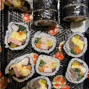 Colorful Kimbap rolls packed with fresh veggies, rice, and savory fillings, wrapped in seaweed. A delicious taste of Korean cuisine!