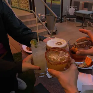 a group of people toasting drinks