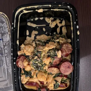 a casserole dish with sausage and spinach