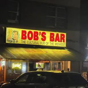 a car parked in front of the bar