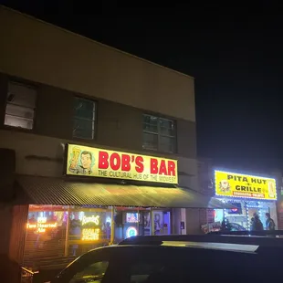 a car parked in front of the bar