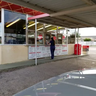 a woman standing in front of a restaurant