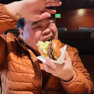 a man eating a hamburger