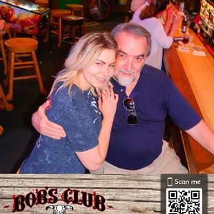 a man and a woman sitting at a bar