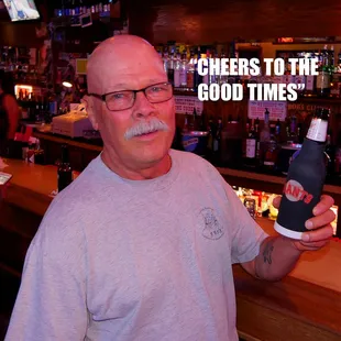 a man holding a bottle of beer