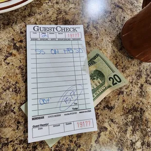 a checkbook and a $ 20 bill