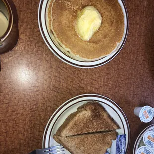 two plates of pancakes with butter on them