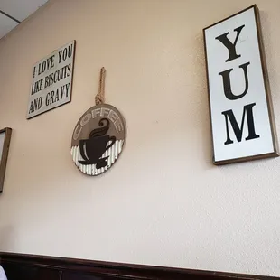 a wall with signs and a clock