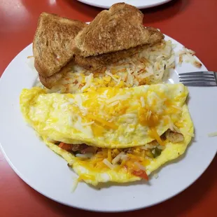 Omelet with onions, peppers, mushrooms, ham and bacon. Came with toast and hash browns.