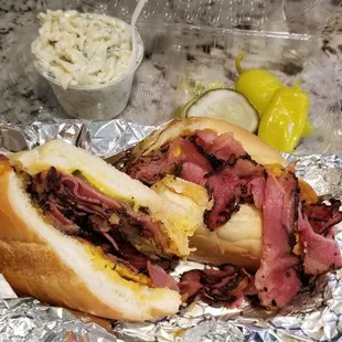 a roast beef sandwich on tin foil