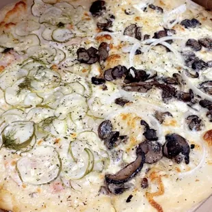 Left half - Pickle Pizza  Right half - Wild Mushrooms Pizza