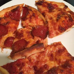 four slices of pepperoni pizza