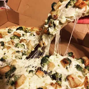 The ATHLETE Signature pizza with a Pesto base, Chicken breast, broccoli, feta and mozzarella cheese