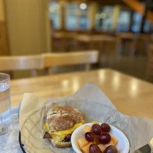 a breakfast sandwich and fruit