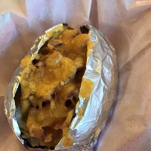 Loaded baked potato with real bacon and cheese - sour cream and butter on side